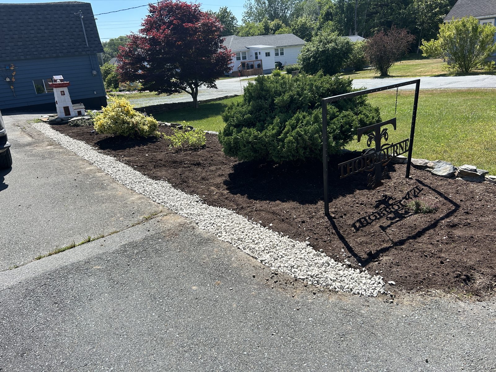 Garden bed after: fresh mulch, clean gravel border, defined edges